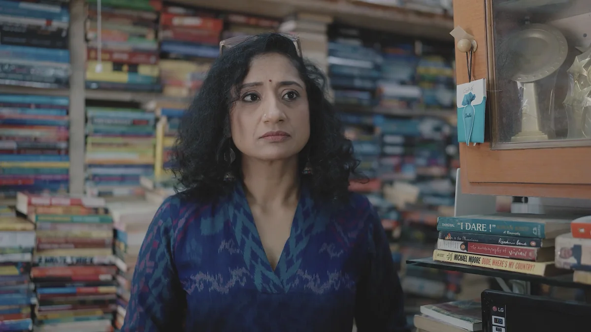 Mugdha Raj in her bookshop, surrounded by stacked books